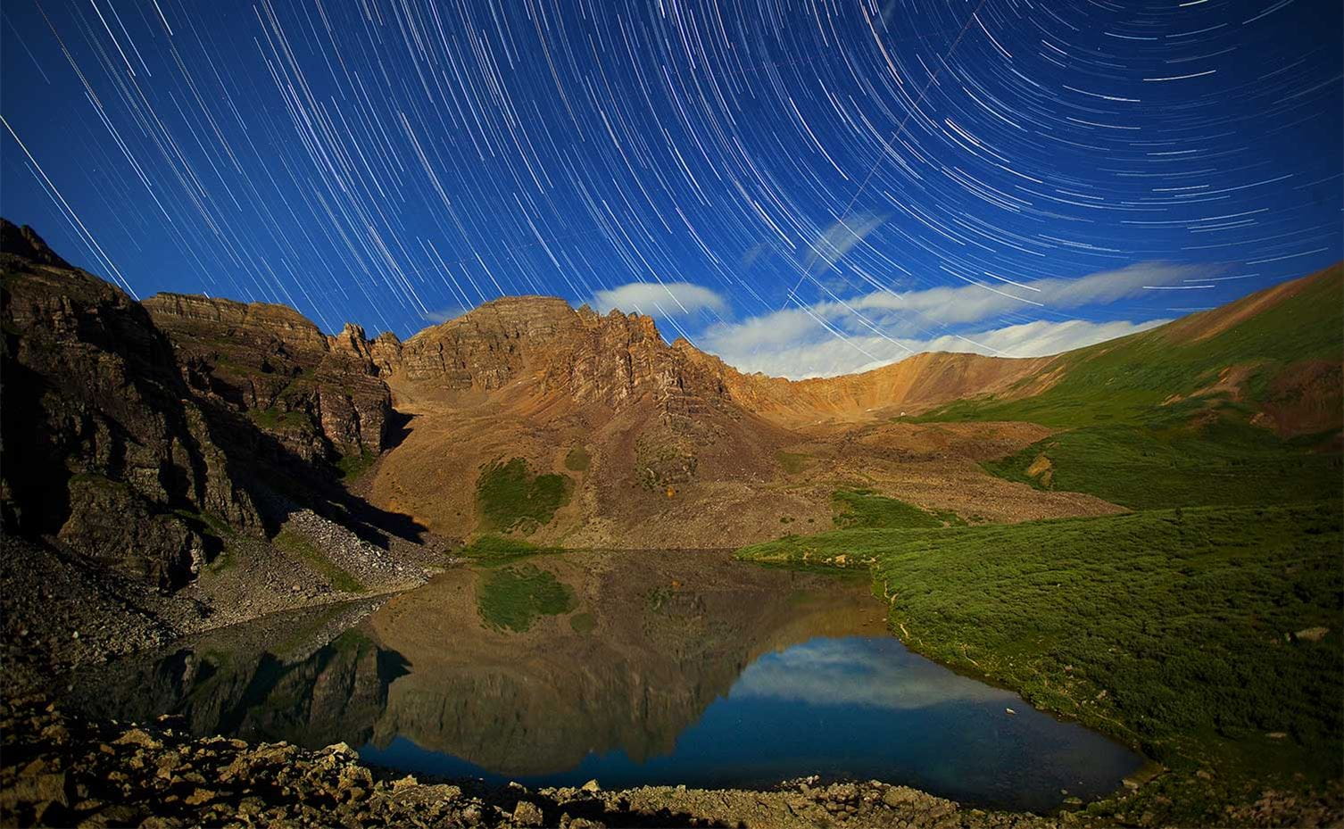 Star trails over a mountain lake in Colorado