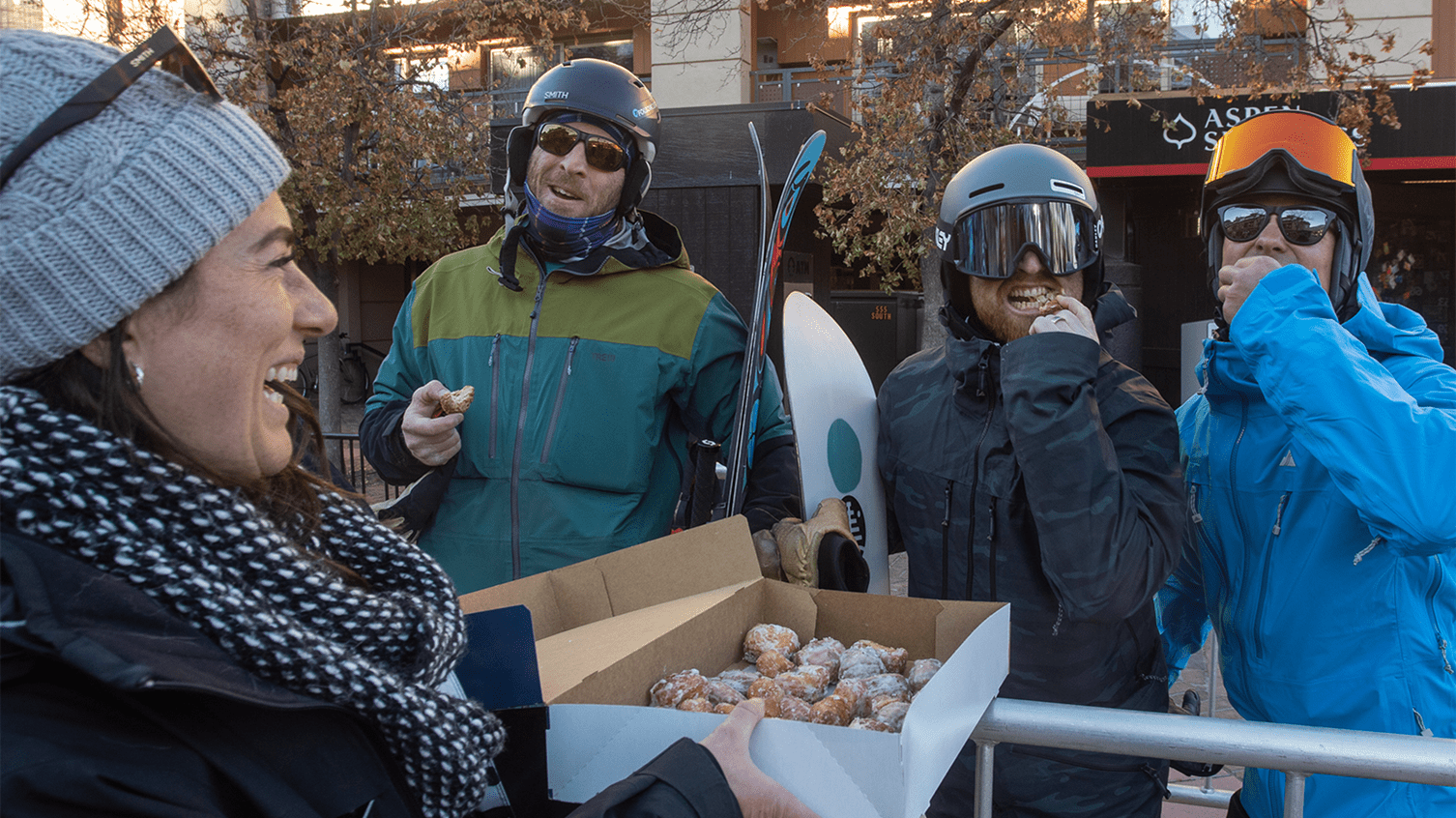 Aspen Snowmass ambassador hands out doughnuts to excited guests