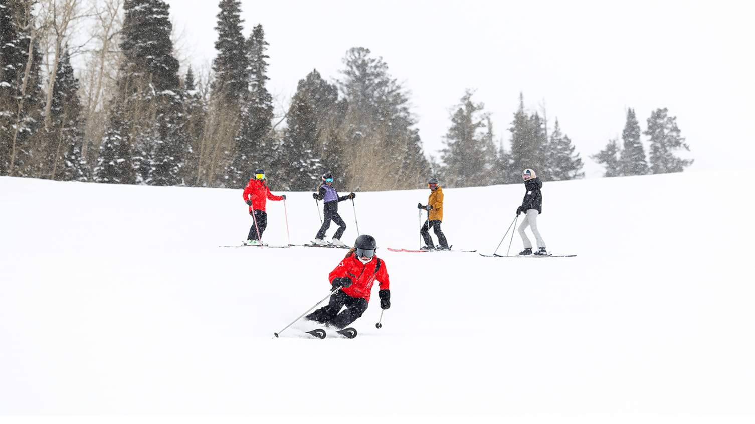 Ski instructor leads group at Aspen Snowmass