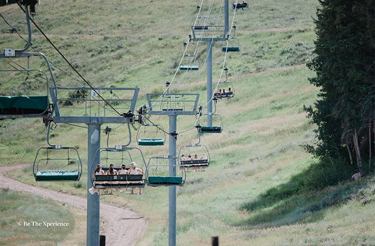 Bridal party rides the chairlift to the wedding at Buttermilk