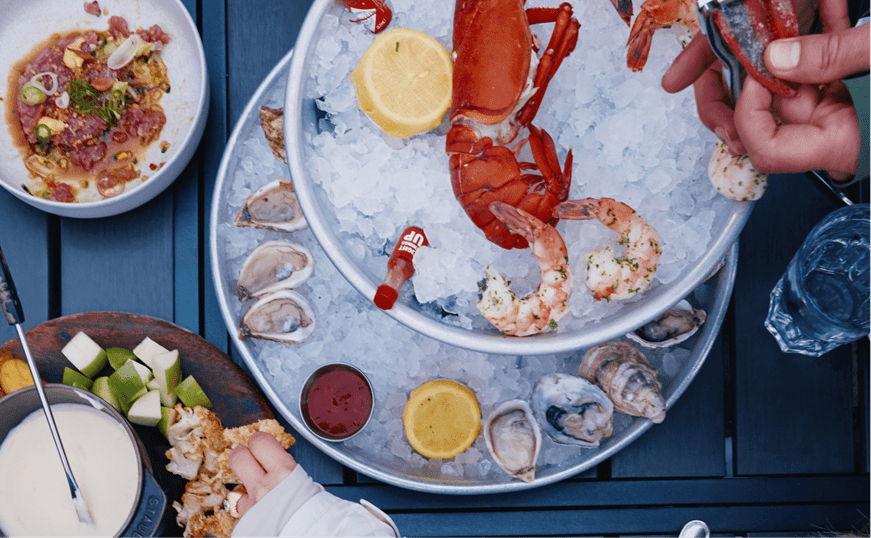 ice dish with lobster and varies sea food options on black table at Aspen Mountain