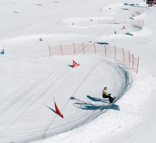 Snowboarder on the banked slalom course
