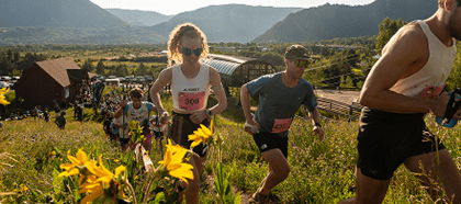 Group of people start power of four up aspen mountain in the summer