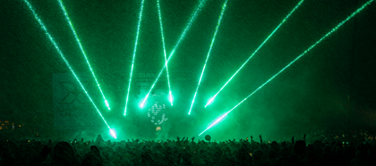 green stage lights over a crowd of people at a winter concert in Aspen
