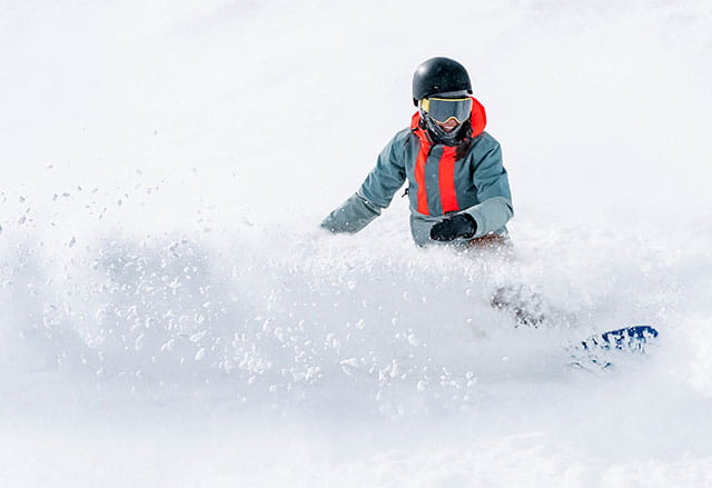 Snowboarder enjoying serious powder at Buttermilk