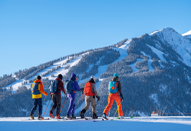 Group of uphillers at Aspen Snowmass, with Aspen highlands in the background