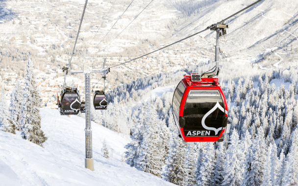 gondola cars at aspen snowmass on a winter day, going up the mountain