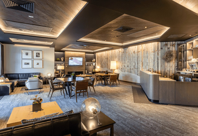 Interior view of Snowmass Mountain Club, warm glowing lights over comfy furniture