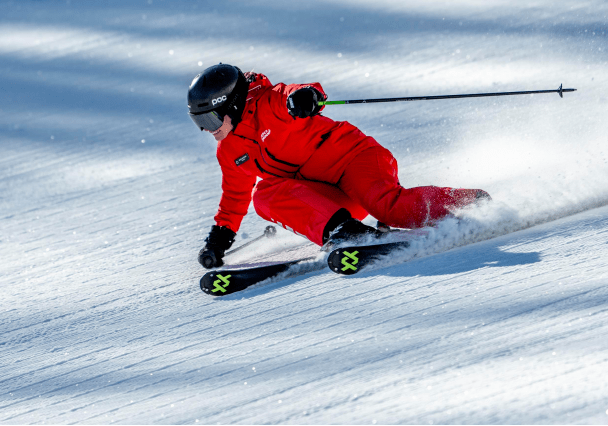single ski pro on groomed run at Aspen Mountain