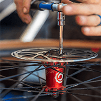 Close up of a bike mechanic working on a bike