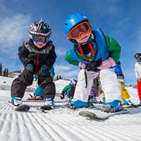 2 to 3 years olds enjoying a skiing lesson