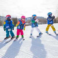 3 to 4 years olds at a skiing lesson