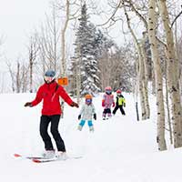 Kids following their ski instructor at Buttermilk