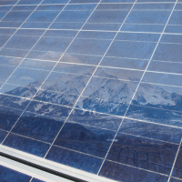 Mountain Sopris's reflection in solar power panels in the roaring fork valley