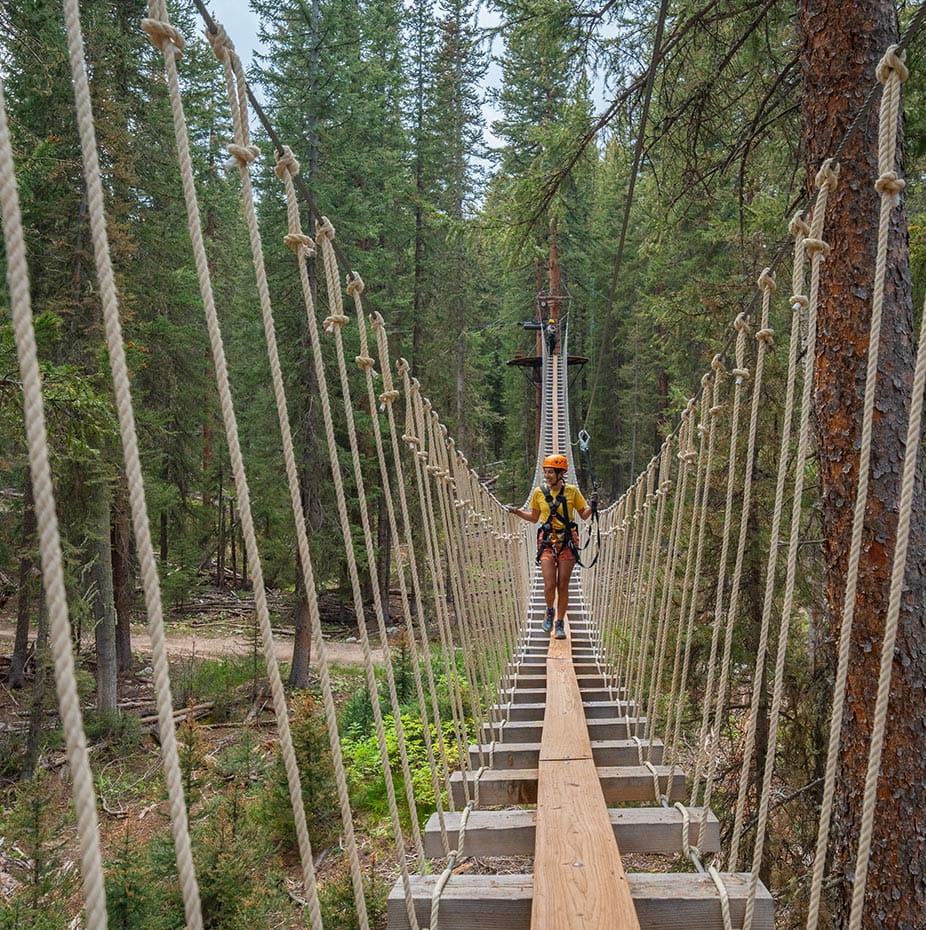Walking across the rope bridge at Lost Forest