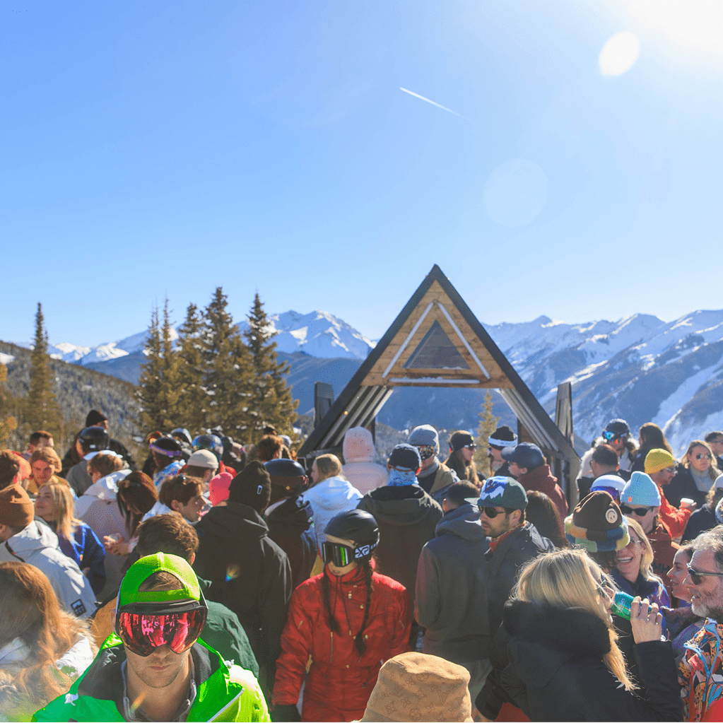 crowd of people listen to music at Eleven212 under blue bird skies