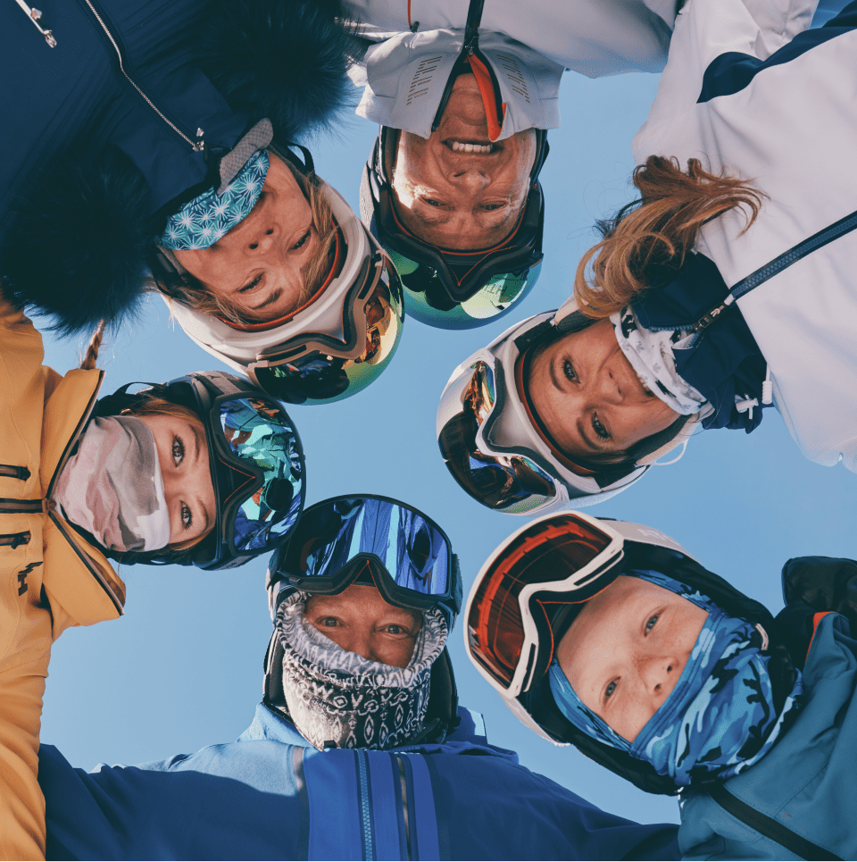 Family looks down at the camera from above, all smiling playfully