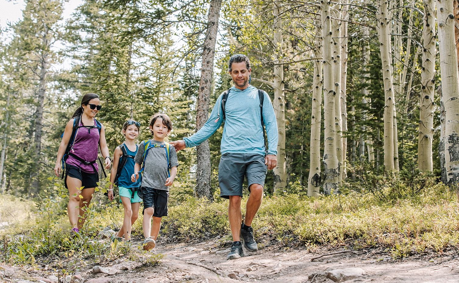 A family enjoys hiking at the Lost Forest