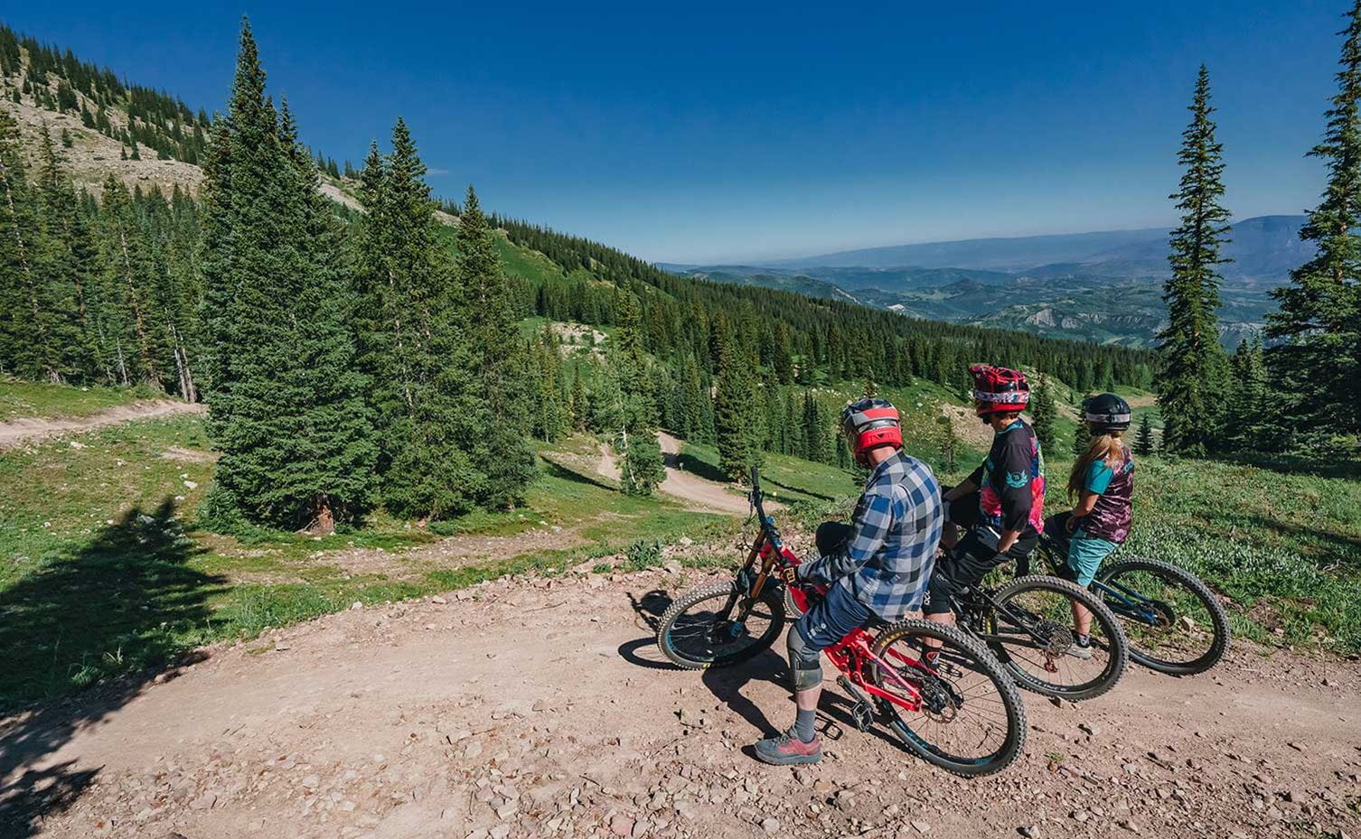 Friends get ready to drop in to the Snowmass Bike Park.