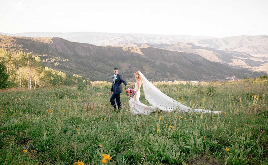 Snowmass wedding couple at Lynn Britt Cabin meadow