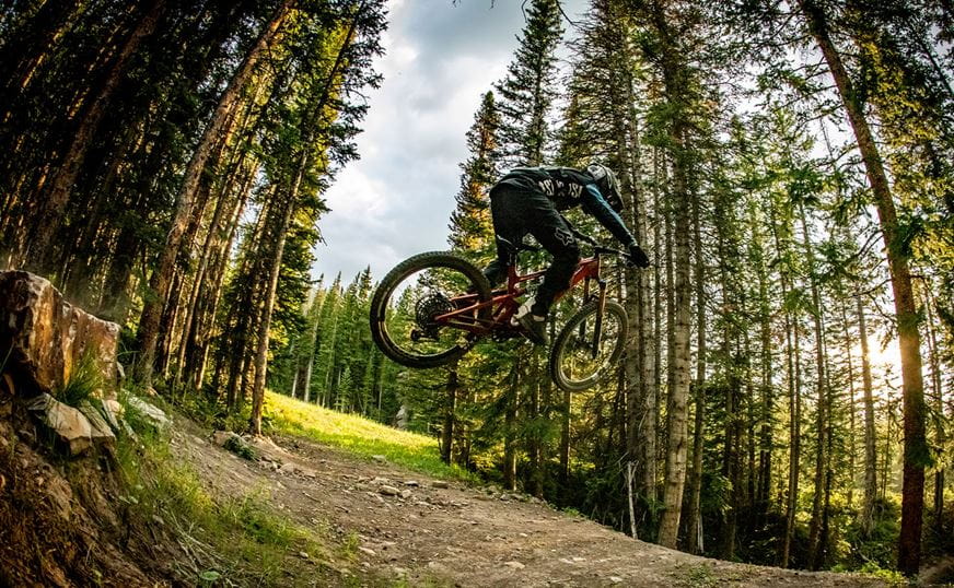 Biker coming down Animal Crackers in the snowmass bike park race series. 