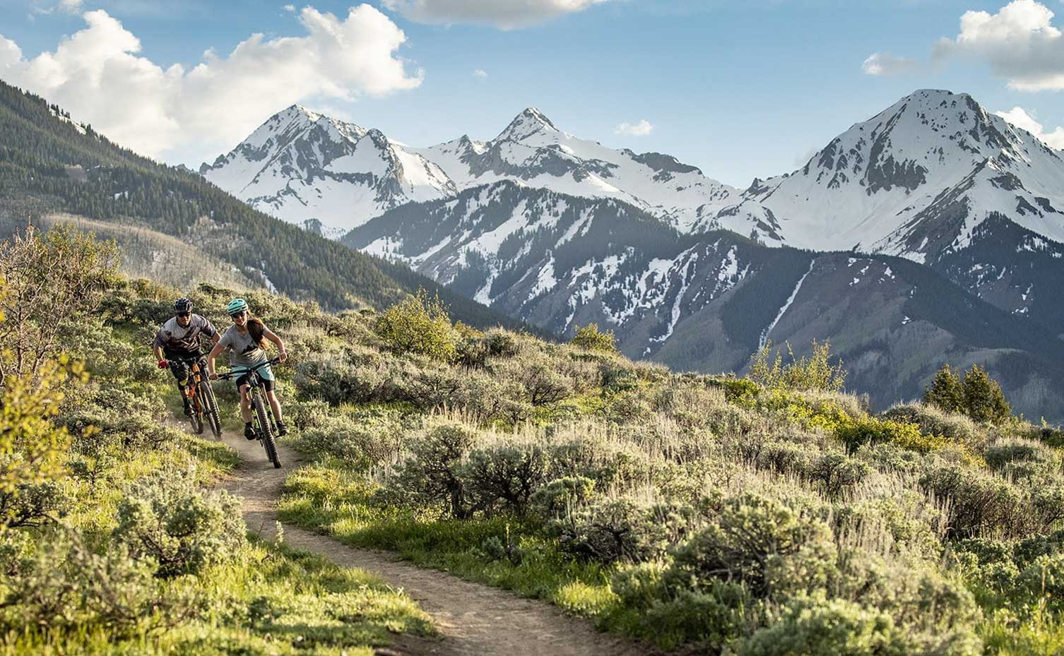 Two mountain bikers riding on a trail near Snowmass