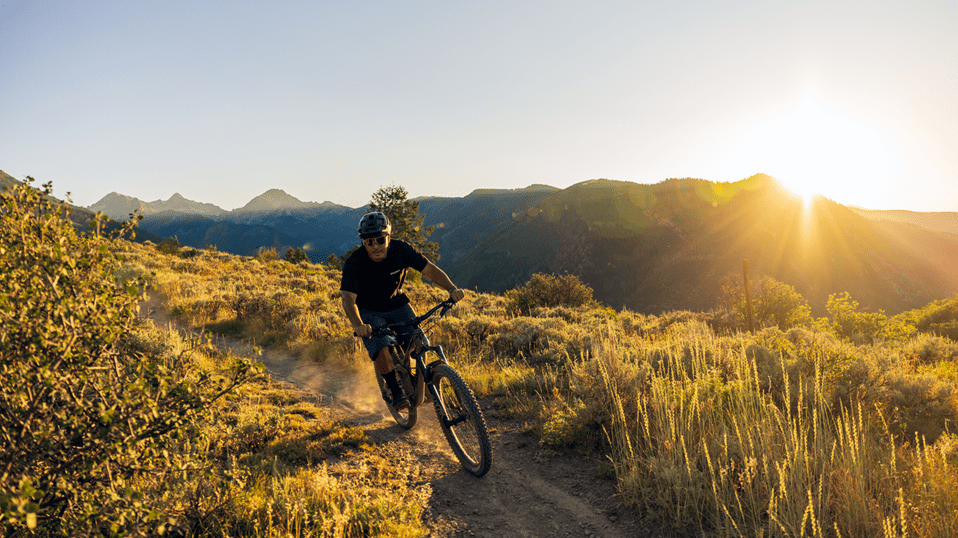 Biker on a trail in Snowmass during sunset