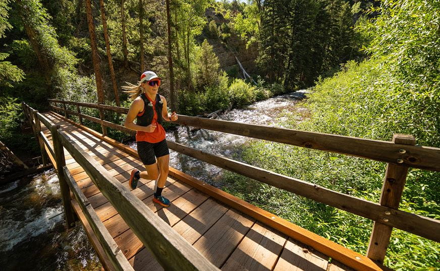 Runner Crossing Maroon Creek Bridge in the Audi Power of Four Trail Race. 