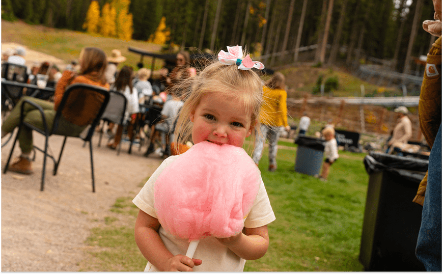 Little girl eating cotton candy