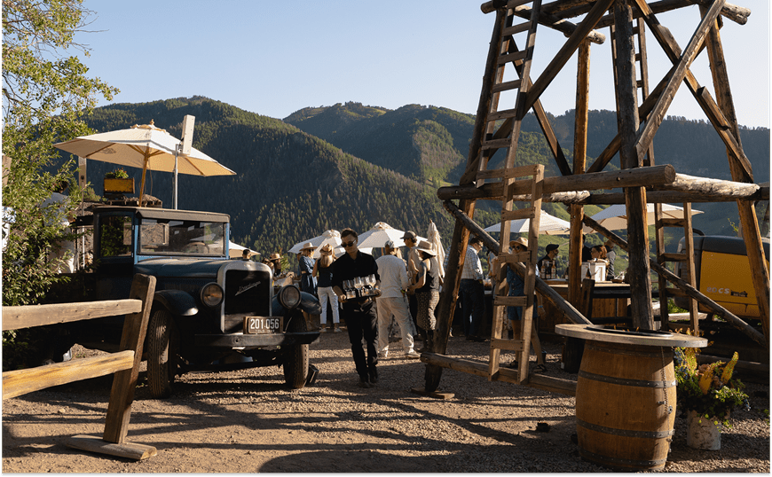 Smuggler Mine view and man carrying wine glasses