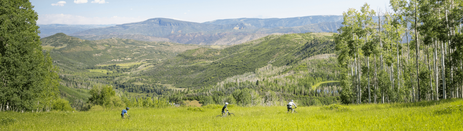 group bikes along a trail in Snowmass