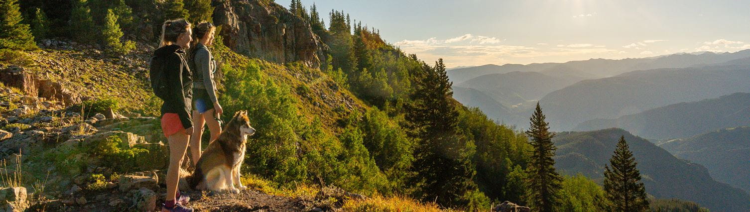 Two girls stand at vista after hiking on snowmass