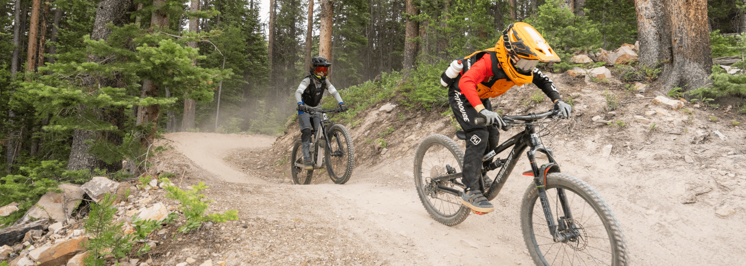 Two kids ride on a bike course during Aspen Snowmass's day camp