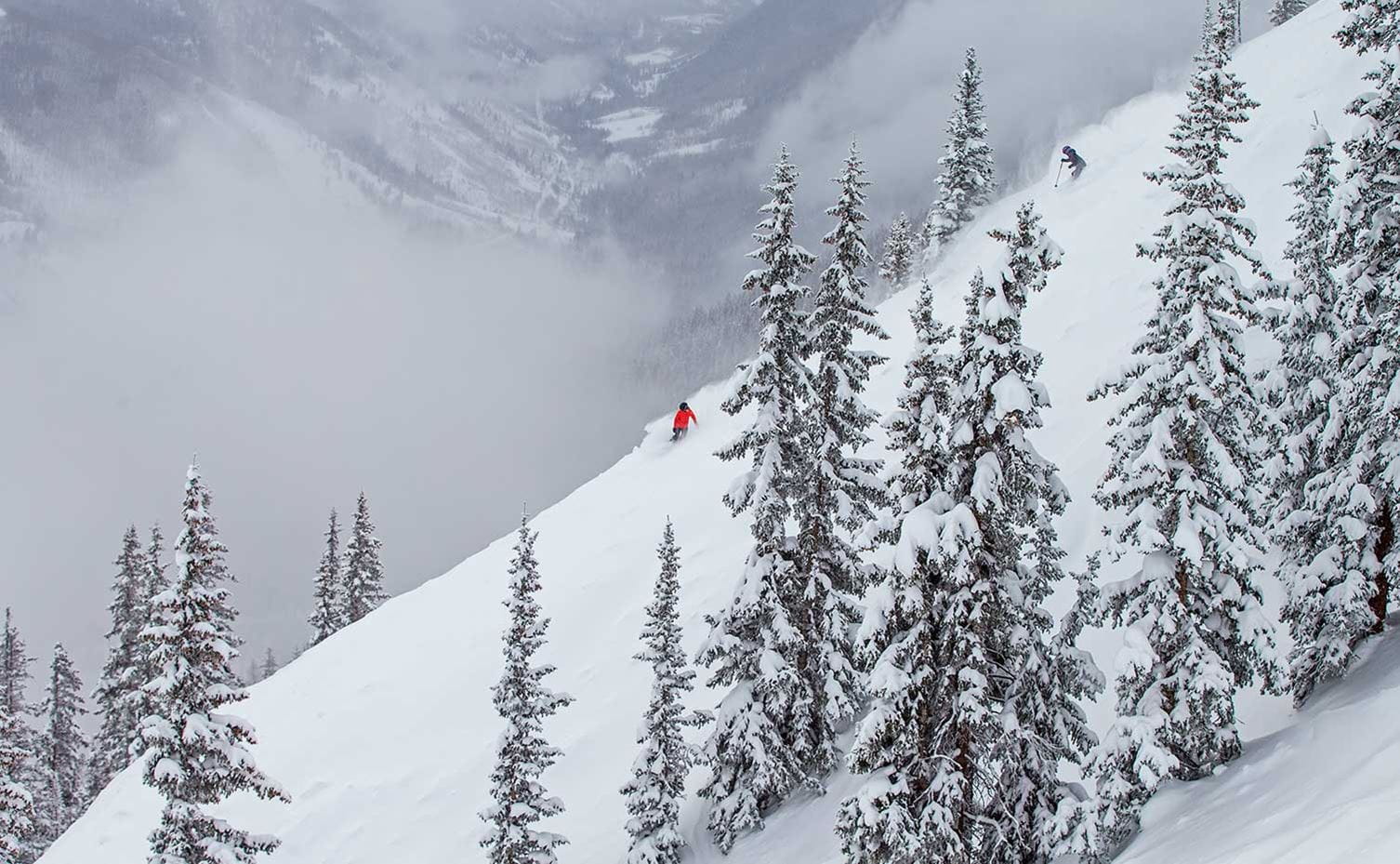 Two skiers enjoy pristine skiing conditions at Aspen Snowmass