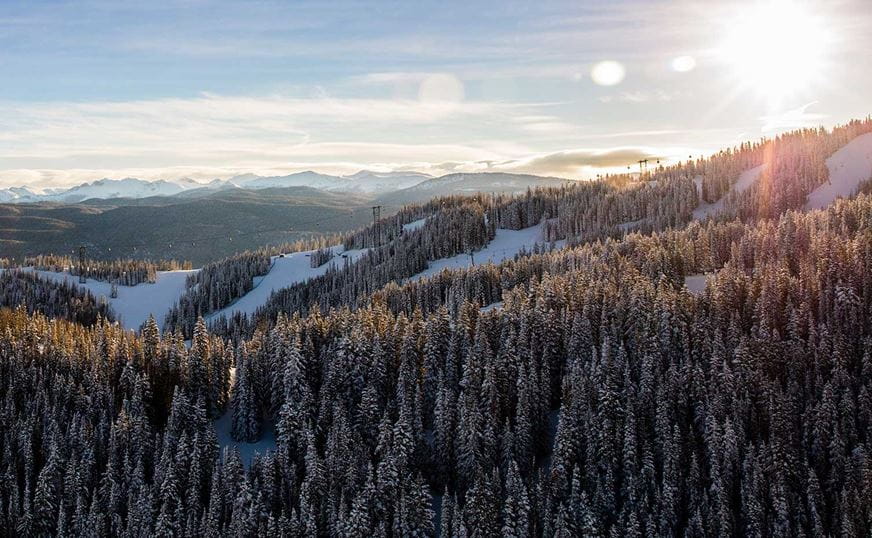 Sunrise over Aspen Mountain in the winter with the Silver Queen Gondola rising along the ridge