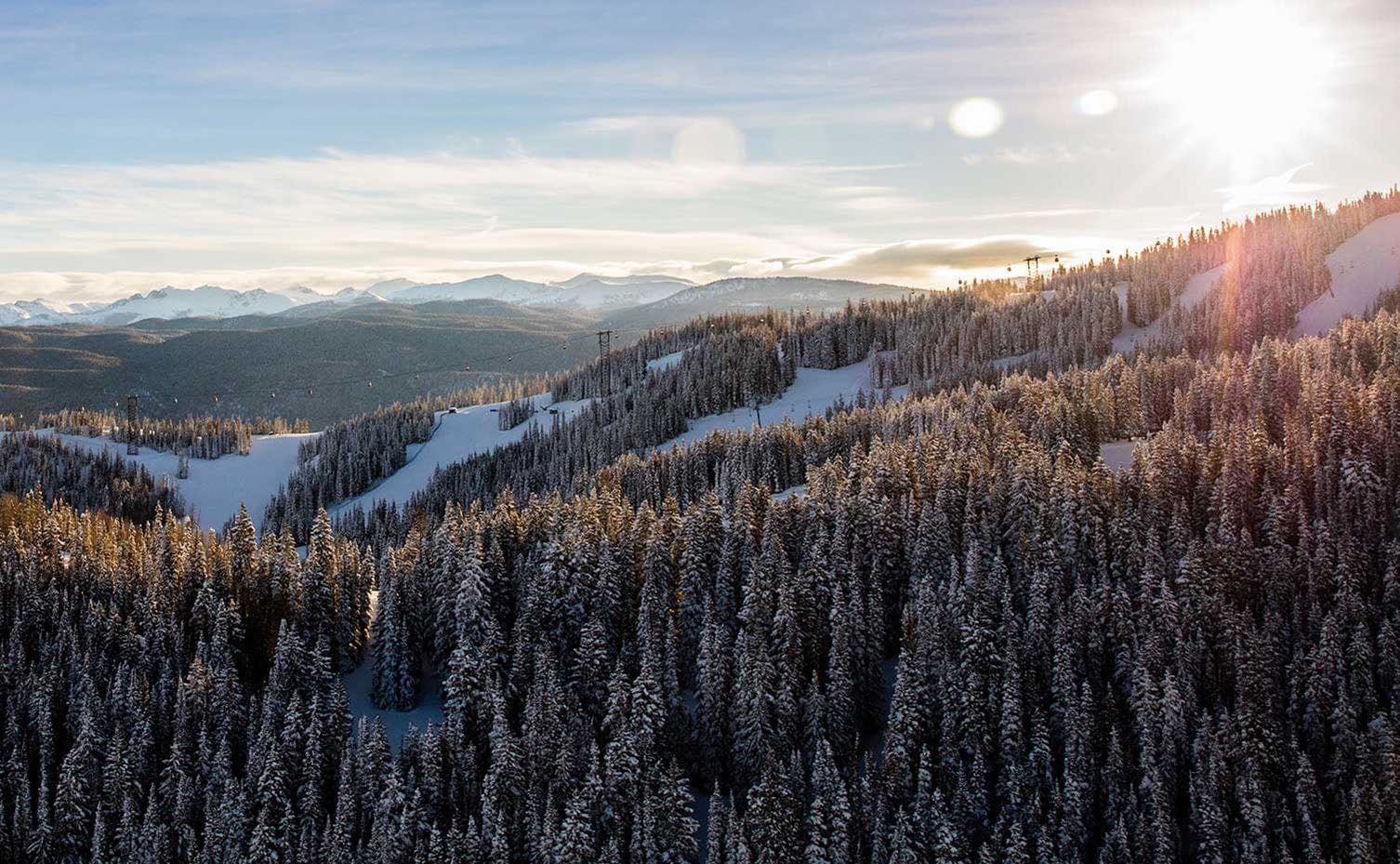 Sunrise over Aspen Mountain in the winter with the Silver Queen Gondola rising along the ridge