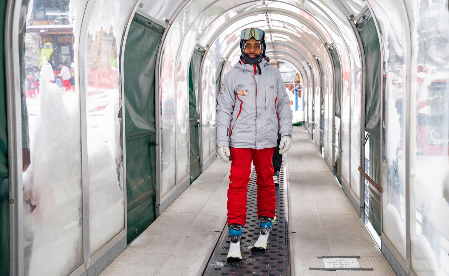 A current employee of Aspen Snowmass rides a magic carpet lift to work