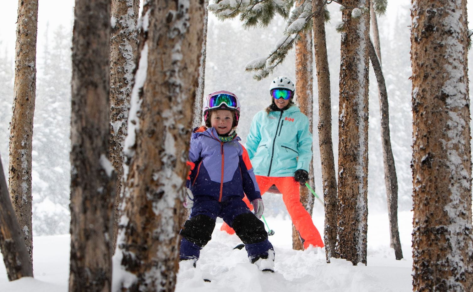A child learning to ski amidst the trees at Aspen Snowmass