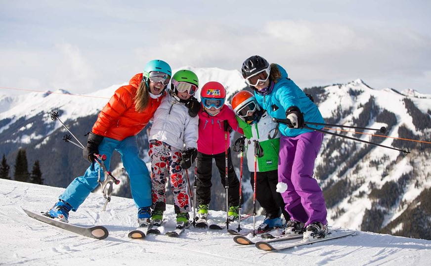 Family posing for photos on top of Aspen Mountain