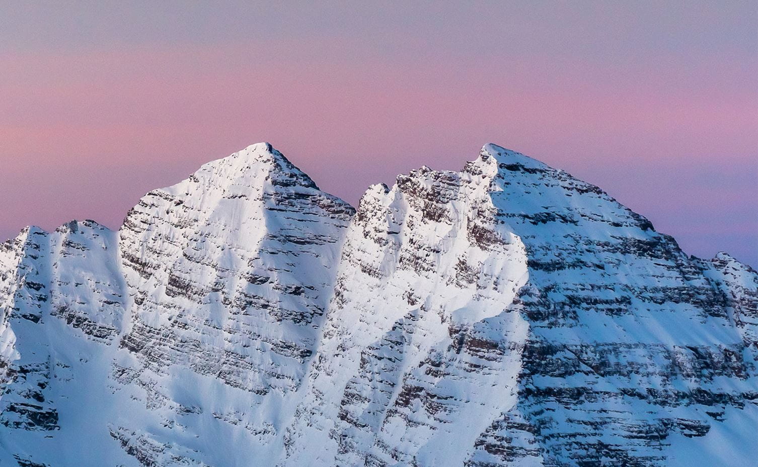 The Maroon Bells in winter at dawn