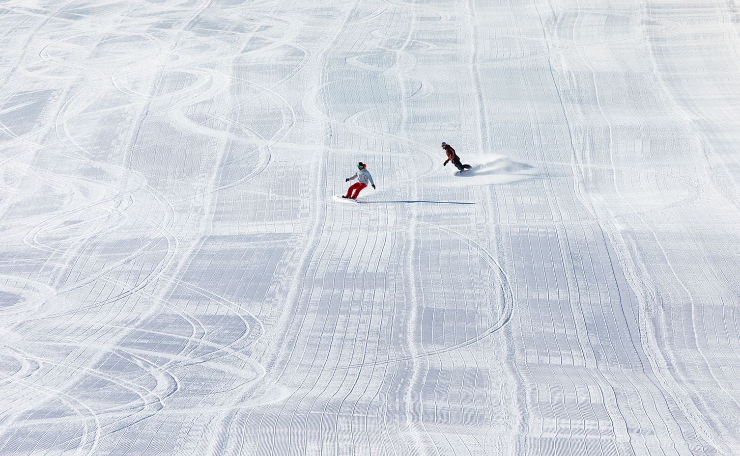 A one-on-one ski lesson on a large groomed run at Aspen Snowmass
