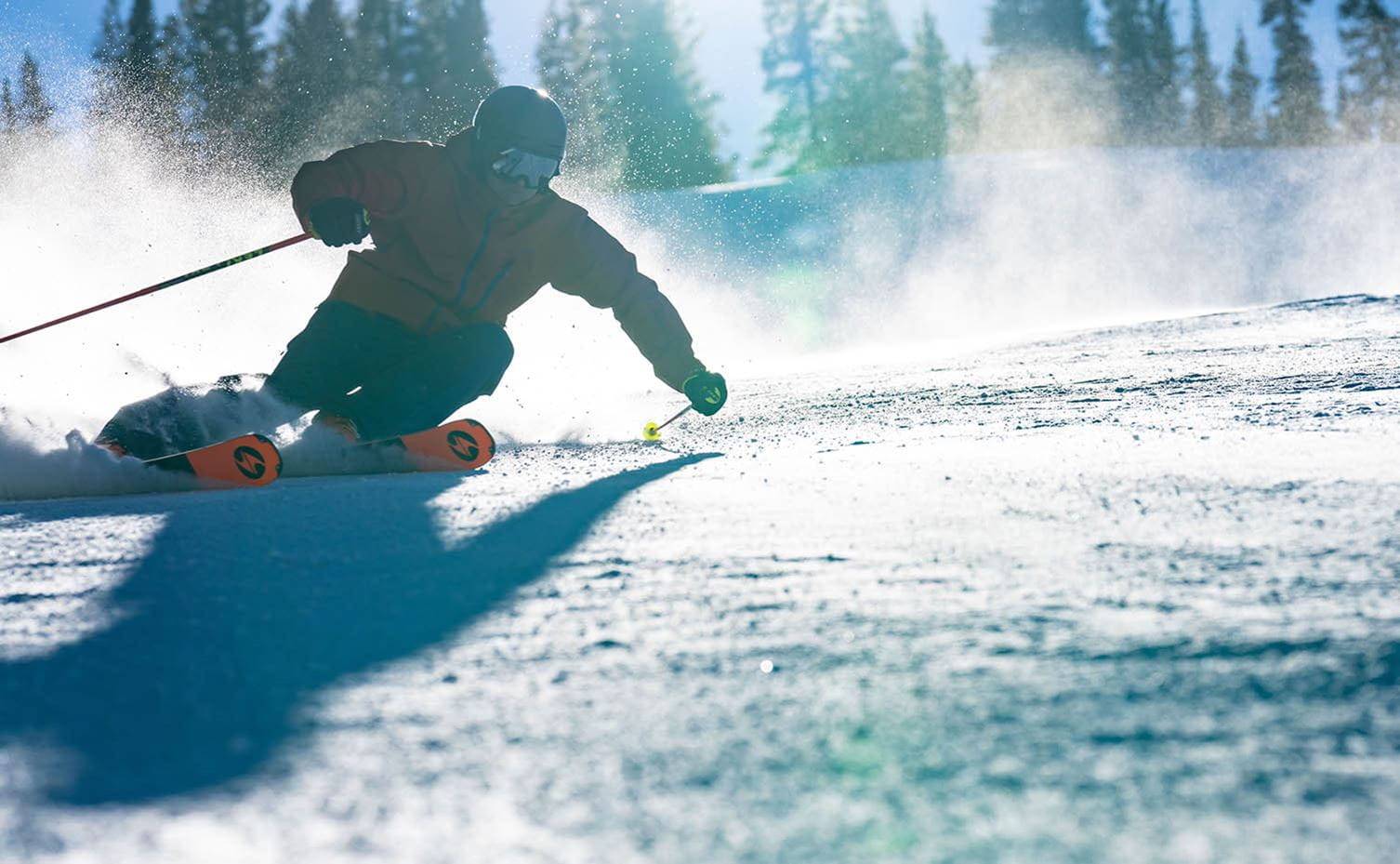 Skier laying down a turn on Aspen Mountain. 