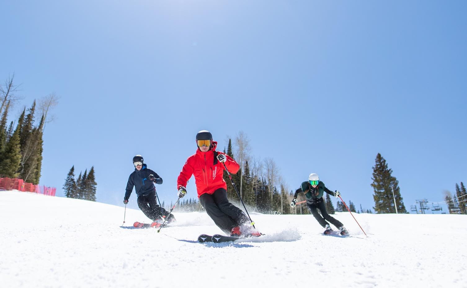 Two people learn to ski from an instructor at Snowmass