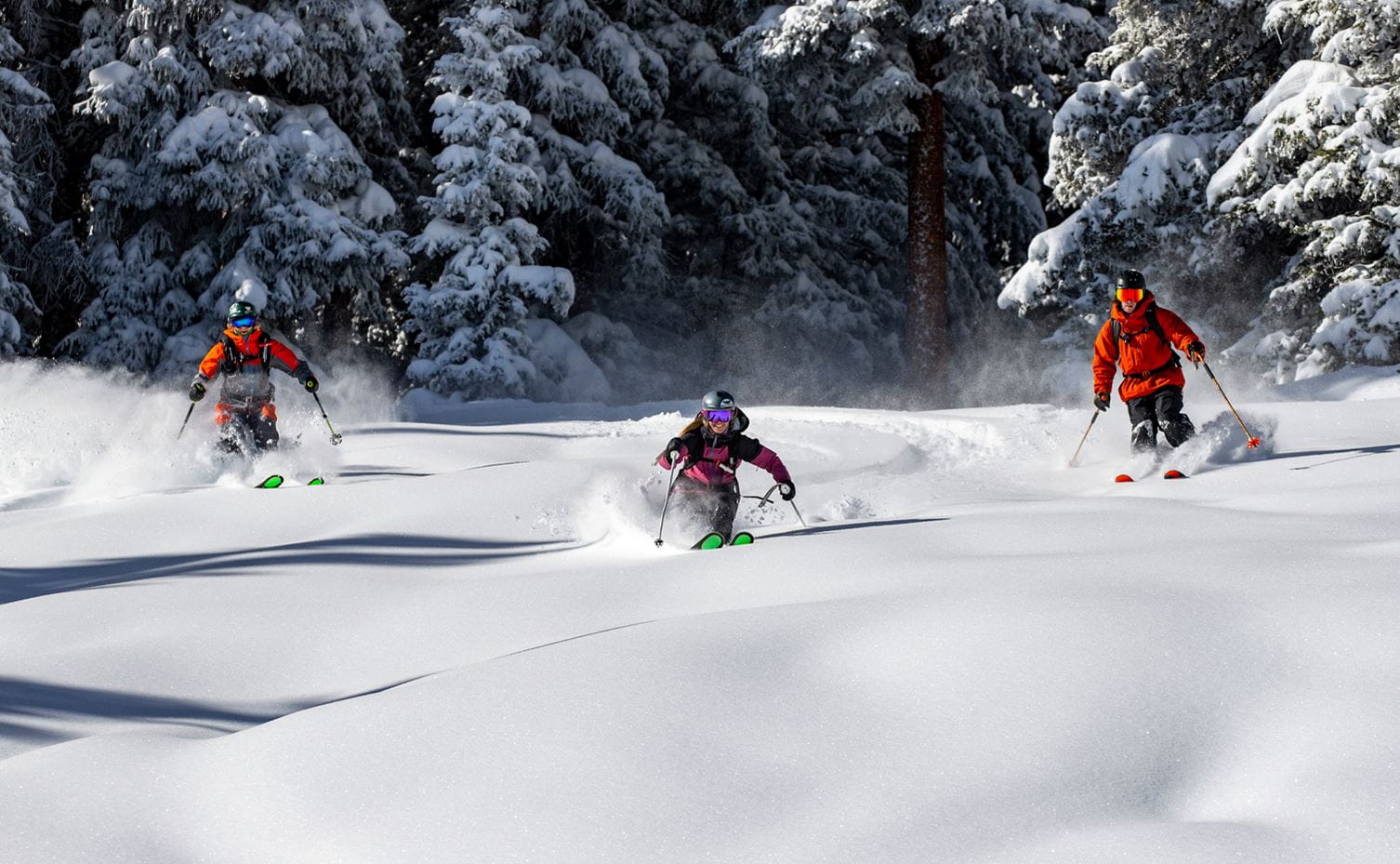 Three skiers enjoy pristine powder at Snowmass
