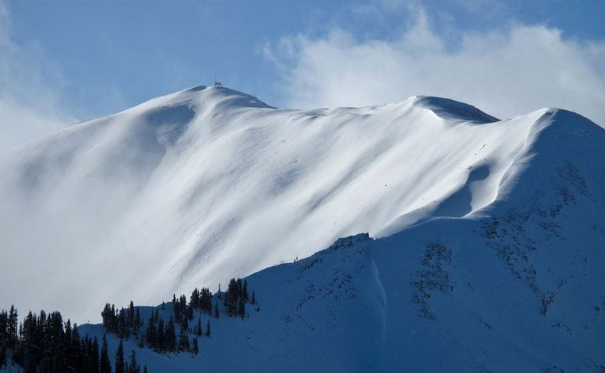 a snowy mountain with trees