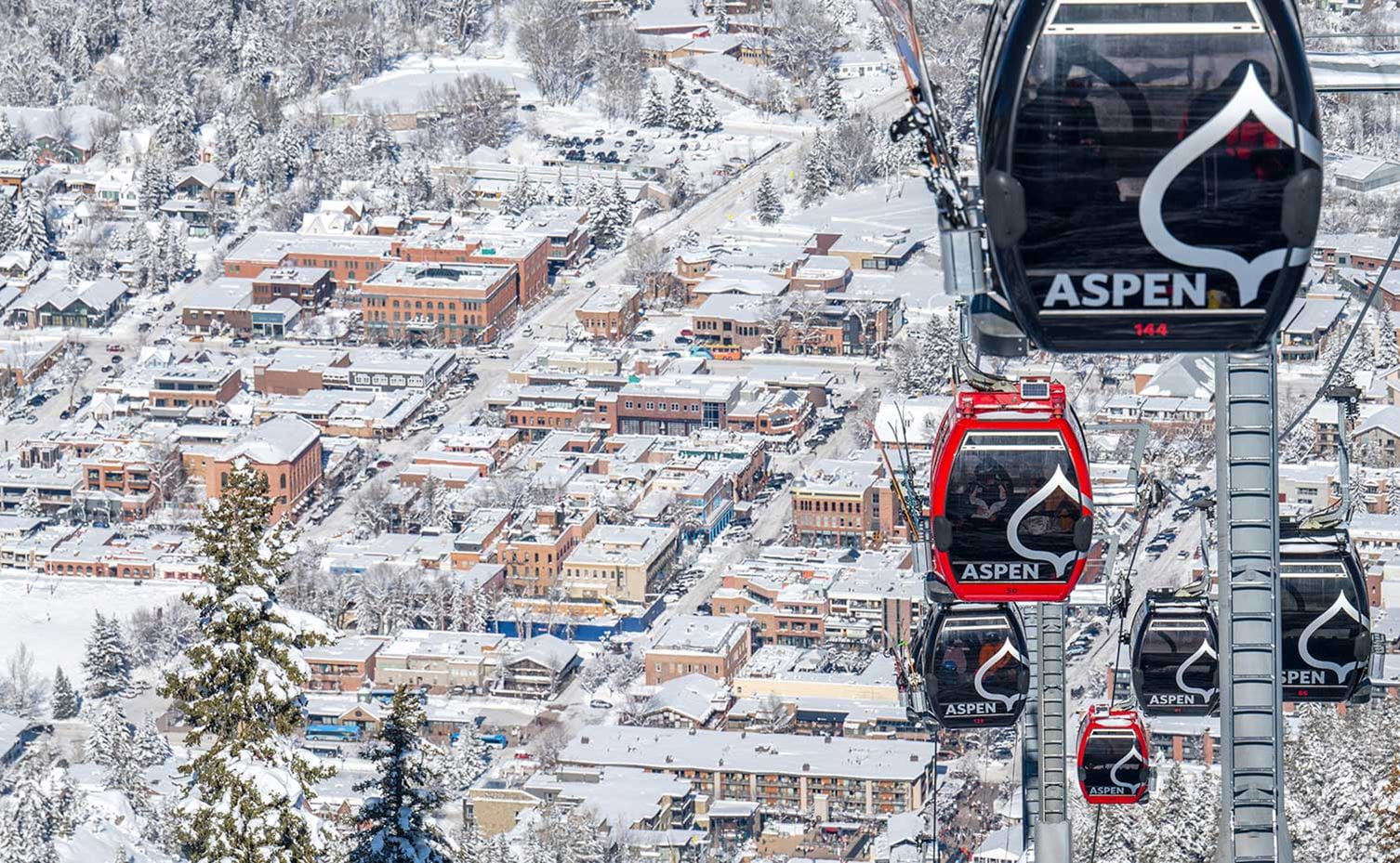 Gondola cars and the city of Aspen in winter