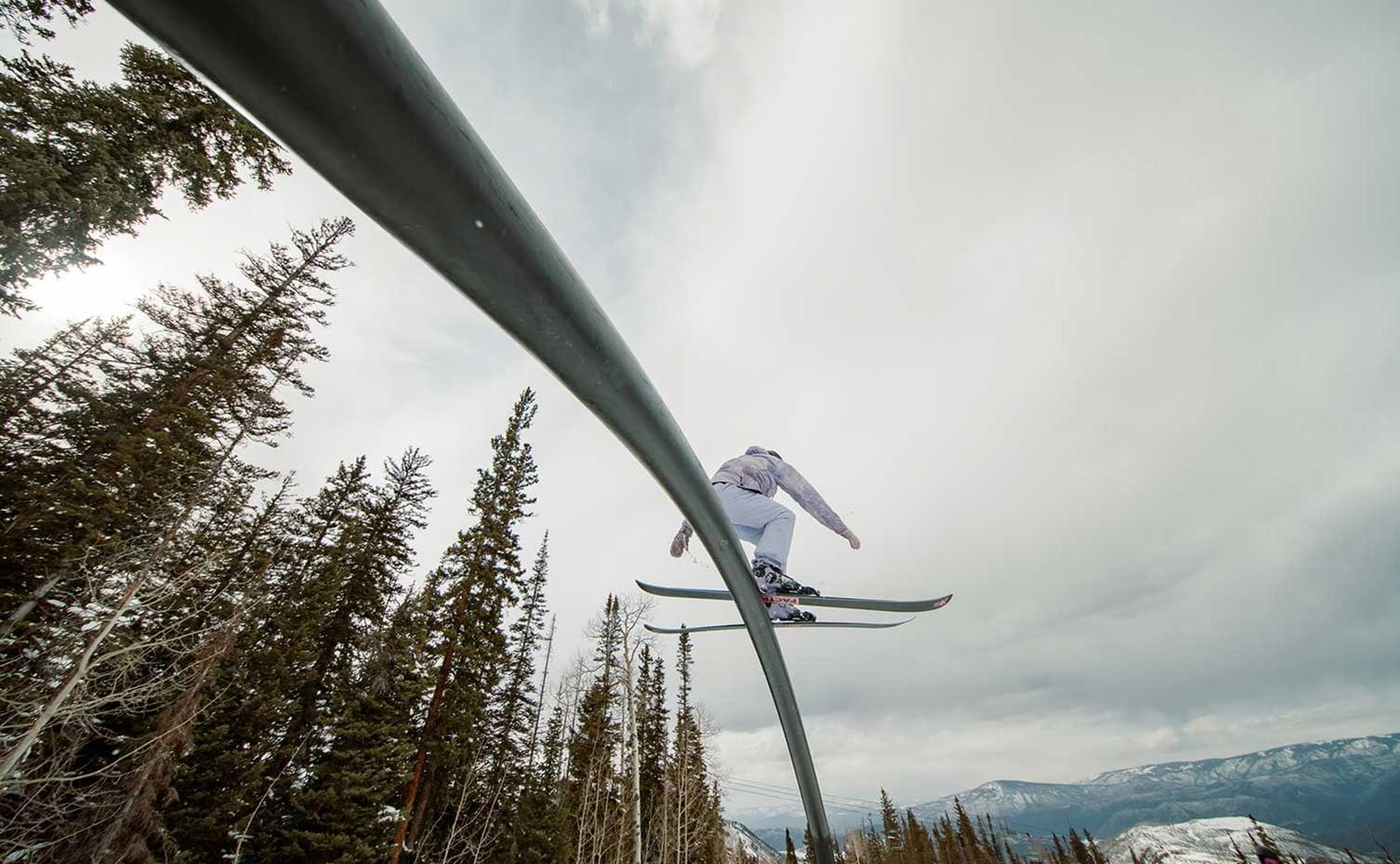 A skier rides a rail at Snowmass' terrain park