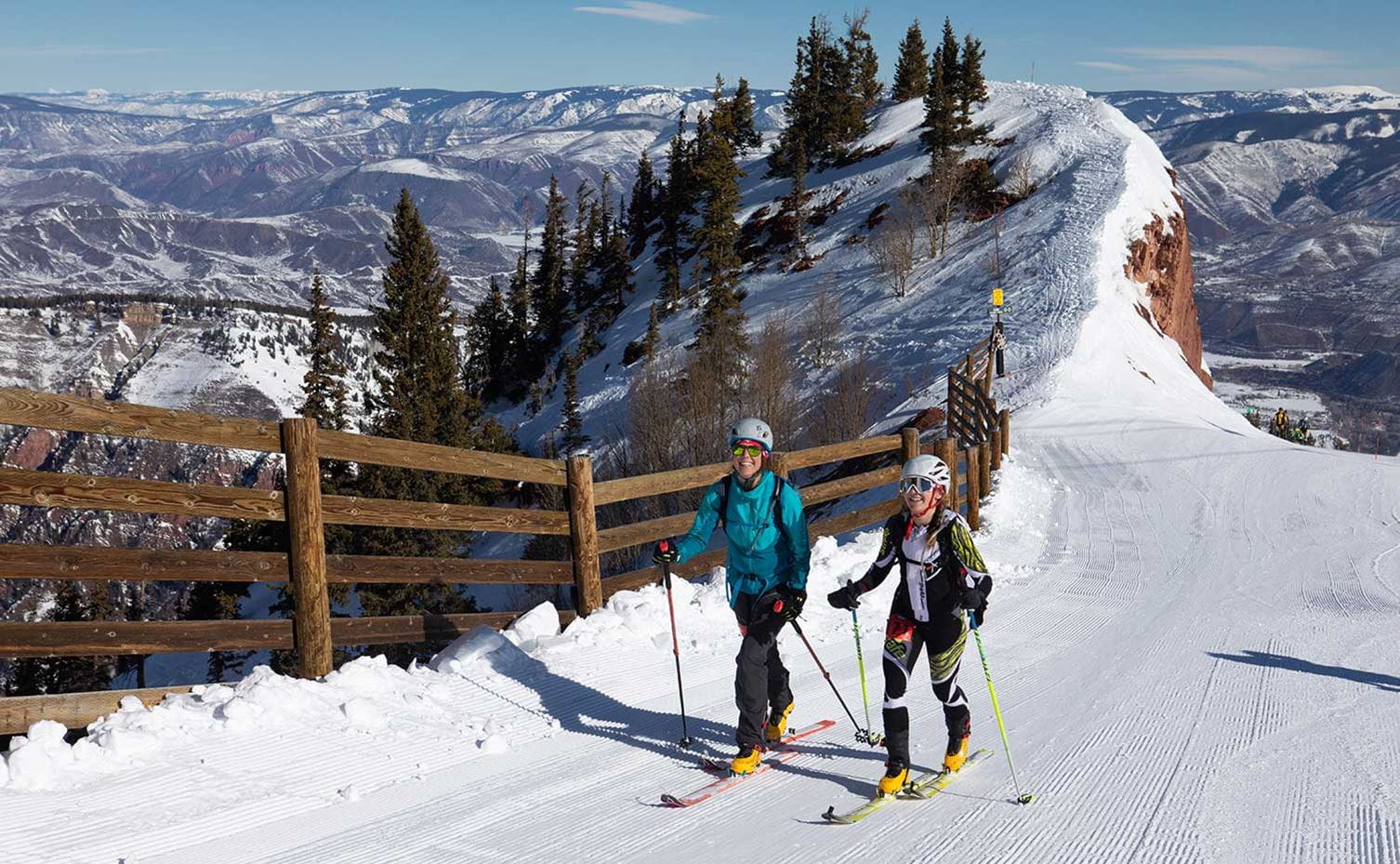 Two uphill skiers atop Aspen Highlands