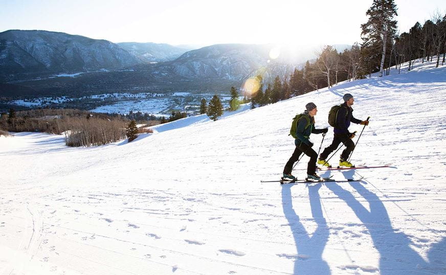 Two uphill skiers go up Buttermilk