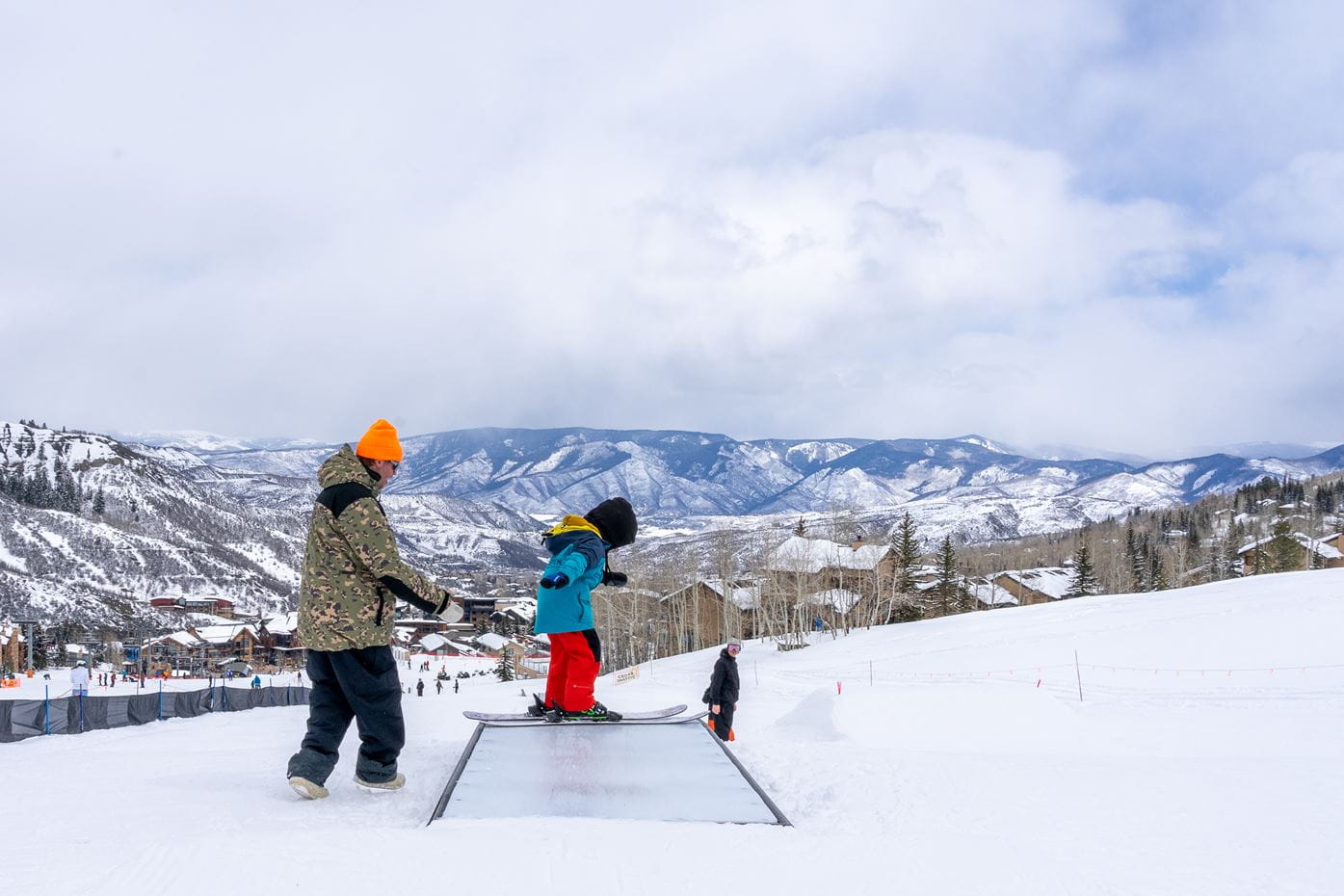 a man and child on a snowboard